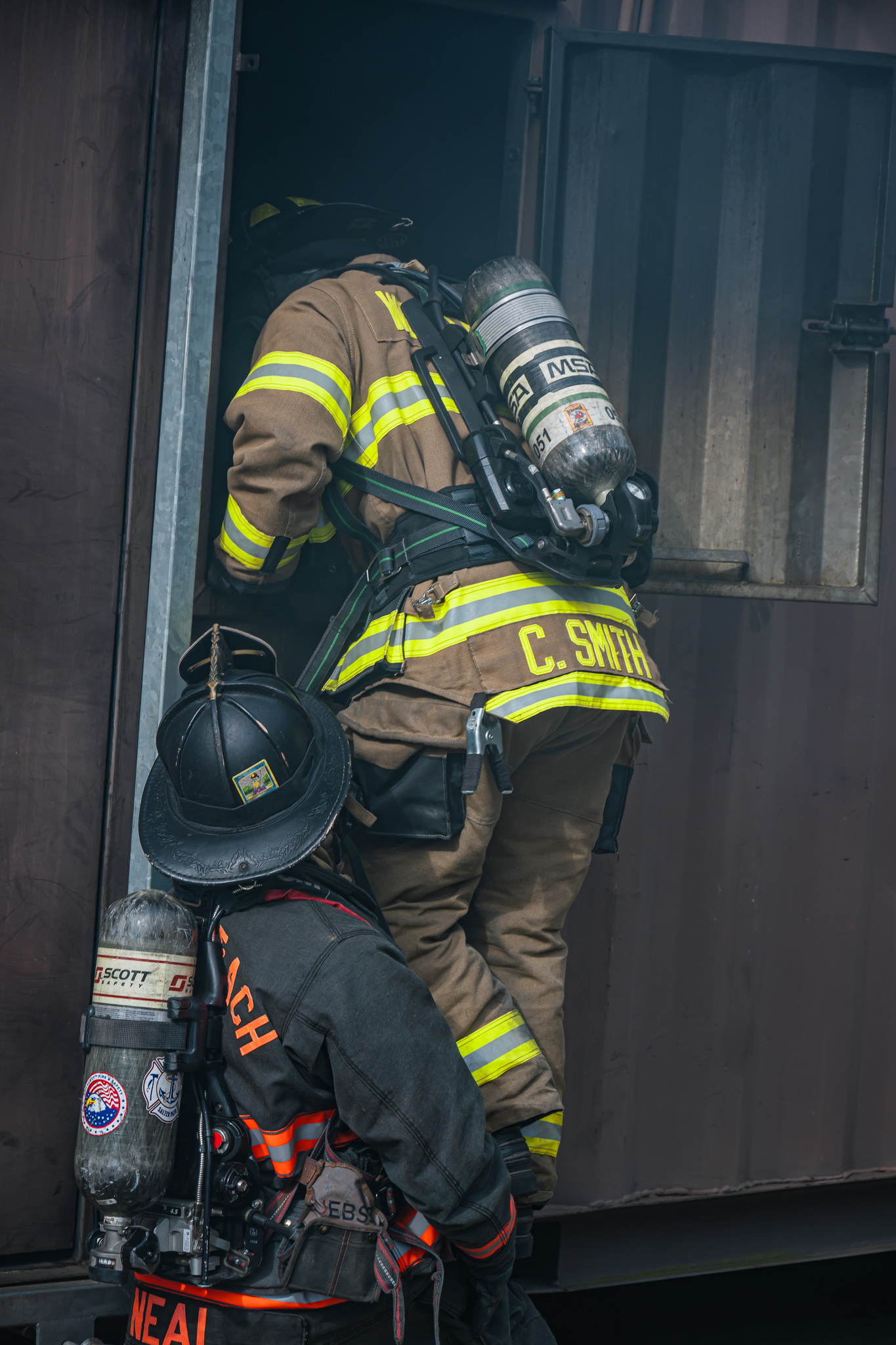 Firefighters entering smoke container